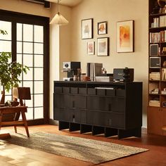 a living room filled with furniture and lots of bookshelves next to a window