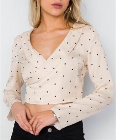 Long sleeves Crop Length Cream with black polka dot print Also available in red Surpliced V-neckline Side button closure inside and outside in wrapped style 100% Polyester No stretch Unlined Model is 5’9 wearing a size Small ( Waist: 26”, Bust: 32C, Hips: 34”) Small measures approximately: Length: 16”, Bust: 34“ Sleeves: 22" Long Sleeve Cropped Top, Dots Fashion, Polka Dots Fashion, Plus Size Romper, Cropped Blouse, Trendy Clothes For Women, Crop Blouse, Bohemian Clothes, Fashion Studio