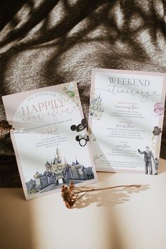 two wedding cards sitting on top of a table next to each other with an envelope