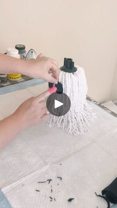 a woman is using a mop to clean the floor