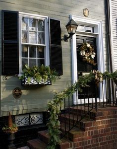 a house with shutters and wreath on the front door