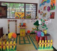 a room with many decorations and pictures on the wall, including a play area for children