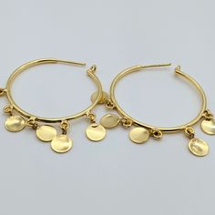 Coin hoop earrings crafted from brass with a gold tone finish feature an inner diameter of approximately 1.7 inches and are designed to be weightless for comfortable wear. These earrings make a perfect addition to any outfit with their classic yet modern appeal. They are also lightweight, ensuring you can wear them all day without any discomfort. 100% brass metal Inner diameter - 1.7 inches Weightless Handcrafted, so expect minor variations Yellow Gold Hammered Metal Hoop Earrings, Hypoallergenic Dangle Hoop Earrings Gold Plated, Hypoallergenic Gold Plated Dangle Hoop Earrings, Modern Gold Plated Dangle Hoop Earrings, Modern Gold Plated Hoop Earrings, Hammered Gold-plated Small Hoop Earrings, Small Gold Plated Hammered Hoop Earrings, Small Hammered Gold-plated Hoop Earrings, Hammered Yellow Gold Dangle Hoop Earrings