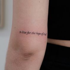 a woman with a tattoo on her arm that says to live for the hope of life