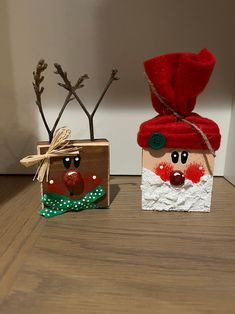 two small boxes decorated to look like santa claus