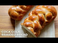 two loaves of bread sitting on top of a cutting board next to each other