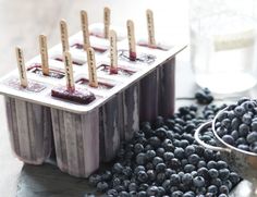 blueberries and popsicles are sitting on the table