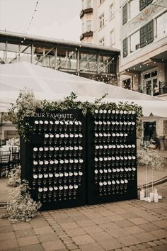 two black and white wedding signs with flowers on them in front of a large building