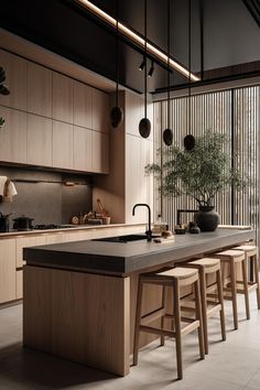 an island in the middle of a kitchen with stools and plants on top of it