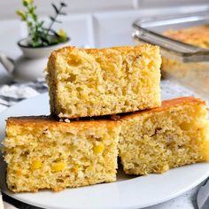 three pieces of cake sitting on top of a white plate next to a potted plant