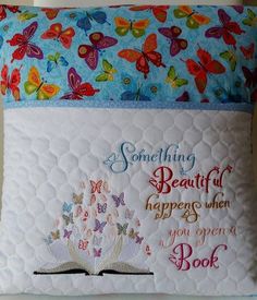 a pillow that has some kind of book on it with butterflies and words written on it