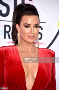 an image of a woman in red dress at the american music awards