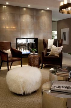 a living room filled with furniture and a fire place in the middle of the room