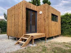 a small wooden building with steps leading up to it