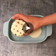 a person is placing an apple pie into a bowl