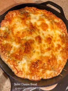 a cheesy pizza sitting in a skillet on top of a stovetop