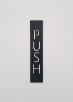 a black and white sign that says push