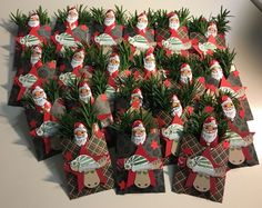 a bunch of small christmas cards with santa clause on them and pine cones in the middle