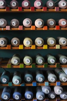 many different colored spools of thread are on the shelves next to each other