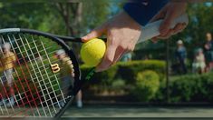 a person holding a tennis racket and ball