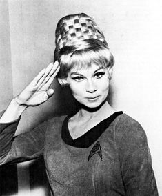 black and white photograph of a woman with her hair in the shape of a star trek helmet