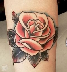 a rose tattoo is shown on the leg