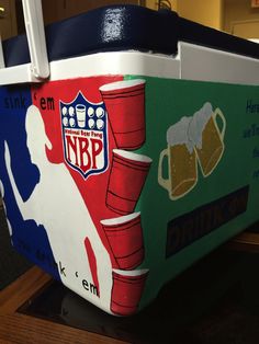 an ice chest with beer mugs painted on the front and sides, sitting on a table