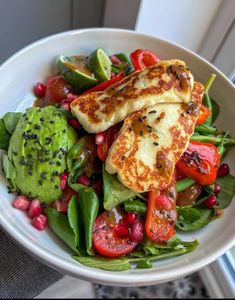 a white bowl filled with vegetables and meat