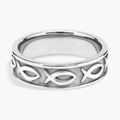 a silver ring with two fish on the side and an arrow in the middle,