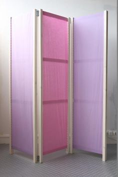 the room divider is pink and purple in color, with two doors on each side