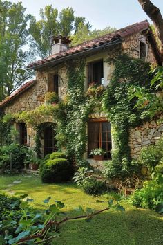 an old stone house with ivy growing all over it