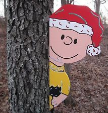 a cardboard cutout of a cartoon character peeking out from behind a tree in the woods