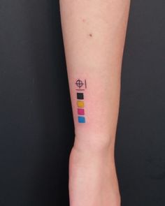 a woman's arm with a colorful tattoo on the left side of her arm