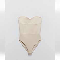 Knit Corset Style Bodysuit Chic Beige Lined Bodysuit, Elegant Spring Bodysuit With Lined Body, Elegant Spring Bodysuit With Built-in Bra, Elegant Beige Sleeveless Bodysuit, Spring Beige Lined Bodysuit, Elegant Beige Bodysuit For Party, Elegant Seamless Beige Bodysuit, Elegant Beige Seamless Bodysuit, Chic Beige Bodysuit For Party