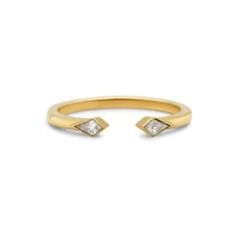 a gold ring with two diamonds on it