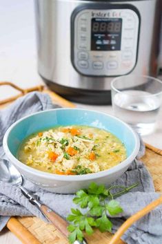 a bowl of chicken noodle soup in front of an instant pot