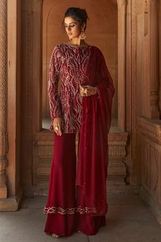 Oxblood straight kurta with cutdana and sequin embellishments. Comes with sharara pants and dupatta.
Component: 3
Embellished
Neckline: Round
Sleeve Length: Full
Fabric: Kurta and Dupatta- Net, Sharara- Organza
Color: Red
Potli button front
Side slits
Embellished sharara pants
Dupatta with sequin embellishment - Aza Fashions Red Sharara, Sharara Pants, Kurta Sharara Set, Red Kurta, Pakistani Formal Dresses, Kurta Sharara, Indian Couture, Party Wear Indian Dresses, Sharara Set