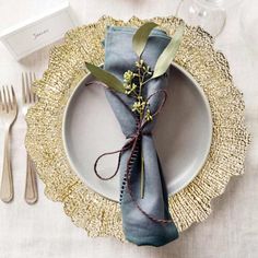 a place setting with silverware and napkins