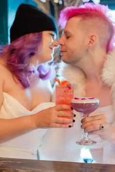 a man and woman sitting next to each other at a bar