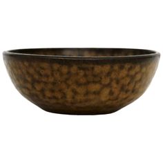 a brown bowl sitting on top of a white table