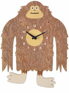 a wooden clock with an image of a monkey on it's face and hands