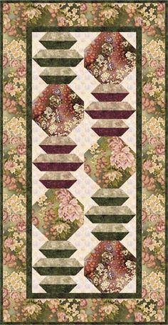 a quilted wall hanging with flowers and leaves on the sides, along with a green border