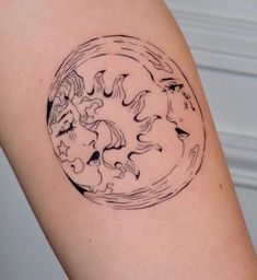 a woman's arm with a black and white tattoo design on the left side of her arm