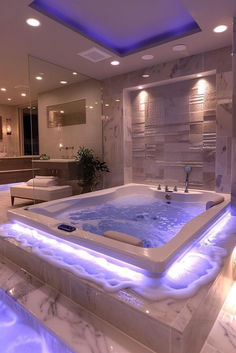 a bathroom with a large jacuzzi tub in the center and lights around it