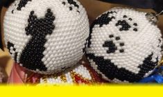 two white and black beaded pandas sitting next to each other