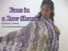 a woman holding up a crocheted shawl with the words, fans in a row shawl