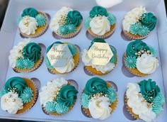 twelve cupcakes with green and white frosting in a box for a happy birthday