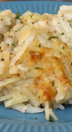 a blue plate topped with pasta covered in gravy and parmesan cheese