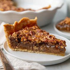 a slice of pecan pie on a white plate