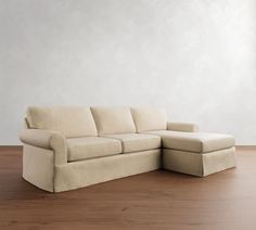 a white couch sitting on top of a hard wood floor next to a wooden floor